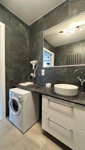 a bathroom with a washing machine and a sink at Baltic Gdańsk OLD TOWN by St Mary s Church in Gdańsk +231 photos
