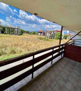 an empty balcony with a view of a field at Mountain Paradise 1 - 1 Bedroom Homey Two Floor Apartment - Washer in Bansko