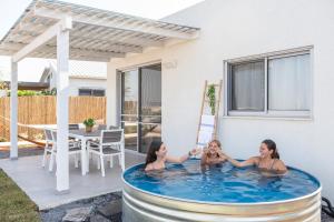a group of three girls playing in a swimming pool at RamotKinneret רמות כינרת in Moshav Ramot