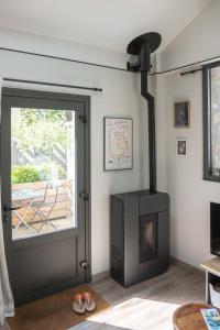 a living room with a wood stove next to a door at Gîte Le Carpe diem Milly-la-Forêt in Milly-la-Forêt