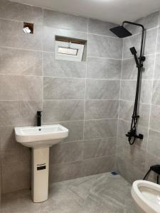 a bathroom with a sink and a toilet at Beaming_House in Sheki
