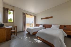 Postel nebo postele na pokoji v ubytování Cát Vàng Hotel & Apartment