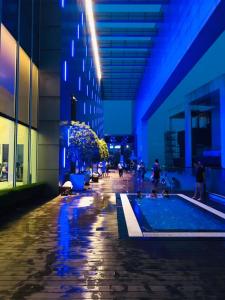 a building with a pool in the middle of a street at KLCC Ritz Residence Platinum in Kuala Lumpur