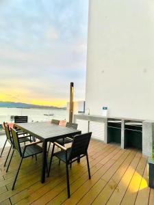 a table and chairs on the deck of a ship at The Shore 12, Kota Kinabalu by HypnosSuites in Kota Kinabalu