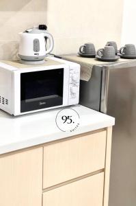 a microwave oven sitting on top of a counter at The Shore 12, Kota Kinabalu by HypnosSuites in Kota Kinabalu
