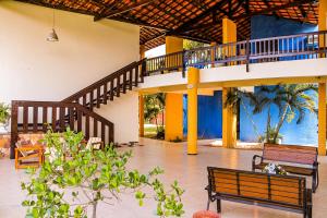 a lobby with two benches and a staircase at Pasargada Hotel in Crato