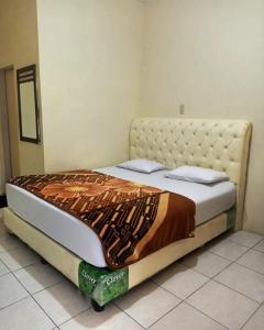 uma cama grande num quarto com em Shohwah Syariah em Berastagi