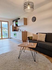 a living room with a couch and a table at Appartement Christina in Going am Wilden Kaiser