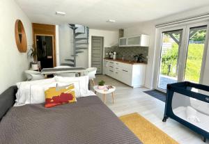 a bedroom with a large bed and a kitchen at P19 Boutique Villa Badacsony in Badacsonytomaj