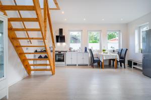 a kitchen and dining room with a table and chairs at Haus am See, exquisites Relaxen in Südbrookmerland