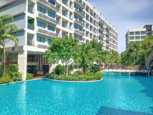 a swimming pool in front of a building at Laguna Beach Resort 3 Maldives in Jomtien Beach
