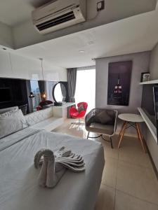 a bedroom with a bed with two pairs of shoes on it at Warhol Residence Semarang Simpang Lima in Semarang