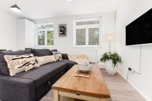 a living room with a couch and a coffee table at Finsbury Park Station Apartment! (B) in London