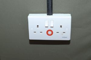 a white switch with a red circle on it at Emunyan Mara Camp in Narok
