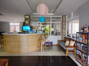 a bar in a room with a couch and a counter at Morning Star Hotel in San Vicente