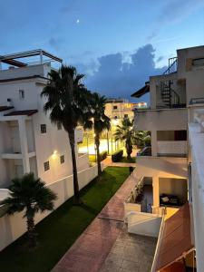 a view from the balcony of a building with palm trees at Ático en el mar in Alcossebre