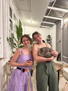 two women in purple dresses holding a baby koala at The PARK Society in Chiang Mai