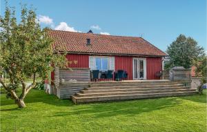 a red house with a red roof and a yard at Nice Home In Bstad With Wifi And 3 Bedrooms in Båstad