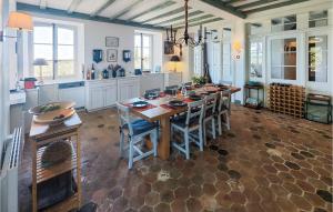 a kitchen with a large wooden table and chairs at Amazing Home In Ouveillan With Outdoor Swimming Pool And 5 Bedrooms in Ouveillan