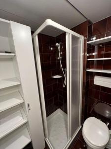 a small bathroom with a shower with a toilet at Residenza Albaré in Marilleva