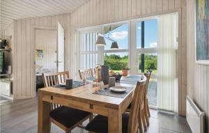 a dining room with a wooden table and chairs at Amazing Home In Hovborg With Kitchen in Hovborg