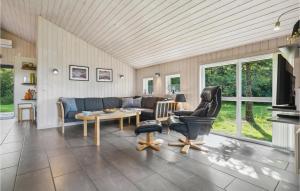 a living room with a couch and a table and chairs at Amazing Home In Hovborg With Kitchen in Hovborg