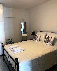 a bedroom with a bed with two bikes on it at John's house in Rhodes Town