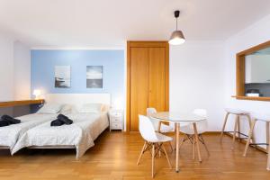 a bedroom with a bed and a table and chairs at Home2Book Charming Studio Santa Cruz City Views in Santa Cruz de Tenerife +30 photos
