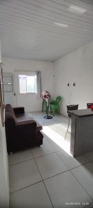 a living room with a couch and a table at casa temporada em Barreirinhas in Marinheiros