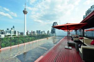 a pool on a building with a view of a city at Red M101 by Oak Tree in Kuala Lumpur