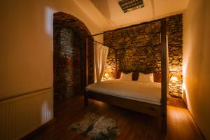 a bedroom with a bed in a stone wall at Michalska Residence 1 in Bratislava