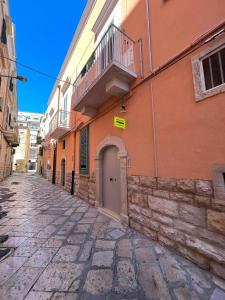 an empty street with a building with a balcony at Il Pepe Affittacamere in Bisceglie