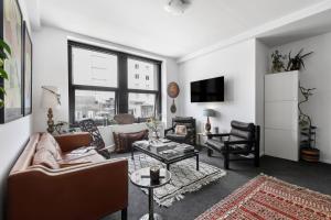 a living room with a couch and a table at 'Eclectic on Degraves St' A High-End Heritage Abode in Melbourne