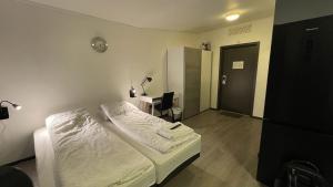Postel nebo postele na pokoji v ubytování SamiCity Hotel As