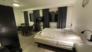 Postel nebo postele na pokoji v ubytování SamiCity Hotel As + 27 fotografií