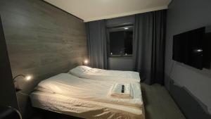 Postel nebo postele na pokoji v ubytování SamiCity Hotel As