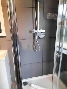 a shower with a glass door in a bathroom at Central Newquay Terrace House in Newquay