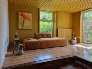 a living room with a couch in a room at Holiday home in rural area with private garden in Leende