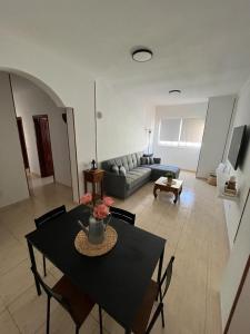 ein Wohnzimmer mit einem Tisch und einem Sofa in der Unterkunft NIVARIA SUITE in Vecindario