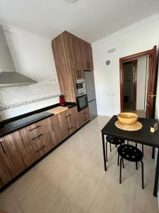 a large kitchen with a table and a counter top at NIVARIA SUITE in Vecindario