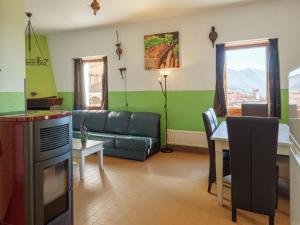 a living room with a couch and a table at Traditional Apartment in Poffabro with Fireplace in Frisanco