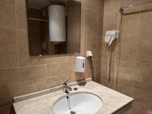 a bathroom with a sink and a phone at 2br Mountain View Apartment - 250mbps Wifi in Bansko