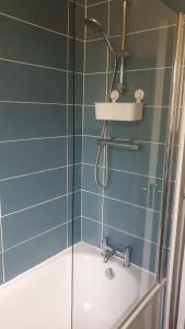 a bathroom with a shower and a sink and a tub at double room in Thornton Heath