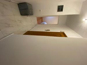 eine weiße Küche mit einem TV an der Wand in der Unterkunft Modern, centrally located apartment in Thessaloniki