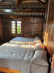 a bedroom with a bed in a wooden cabin at Highland garden - homestay Phú Yên 