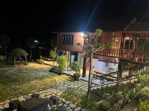 a house at night with a stone walkway in front at Highland garden - homestay Phú Yên 