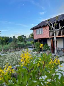 a house with yellow flowers in front of a yard at Highland garden - homestay Phú Yên 