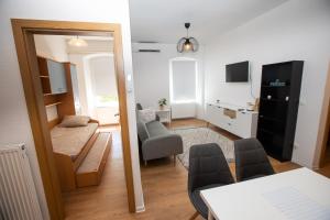 a living room with a couch and a chair and a table at Newly adapted 3-room apartment in Postojna