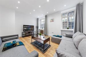 a living room with a couch and a table at Modern Flat in London in London