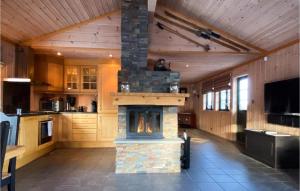a large kitchen with a stone fireplace in a house at 4 Bedroom Lovely Home In Dalen in Dalen
